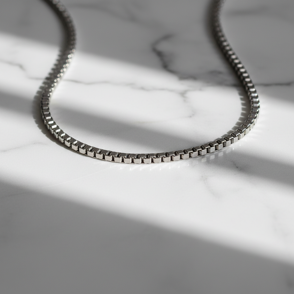 ROVIA Silver Box Chain on white marble surface